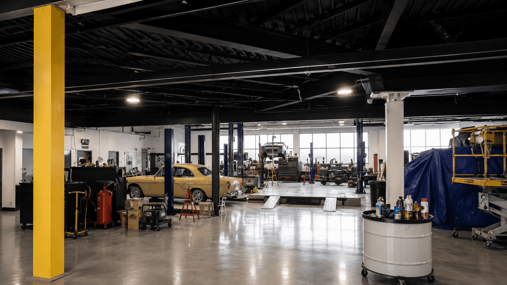 The PMD Garage shop floor with exposed beams and support columns